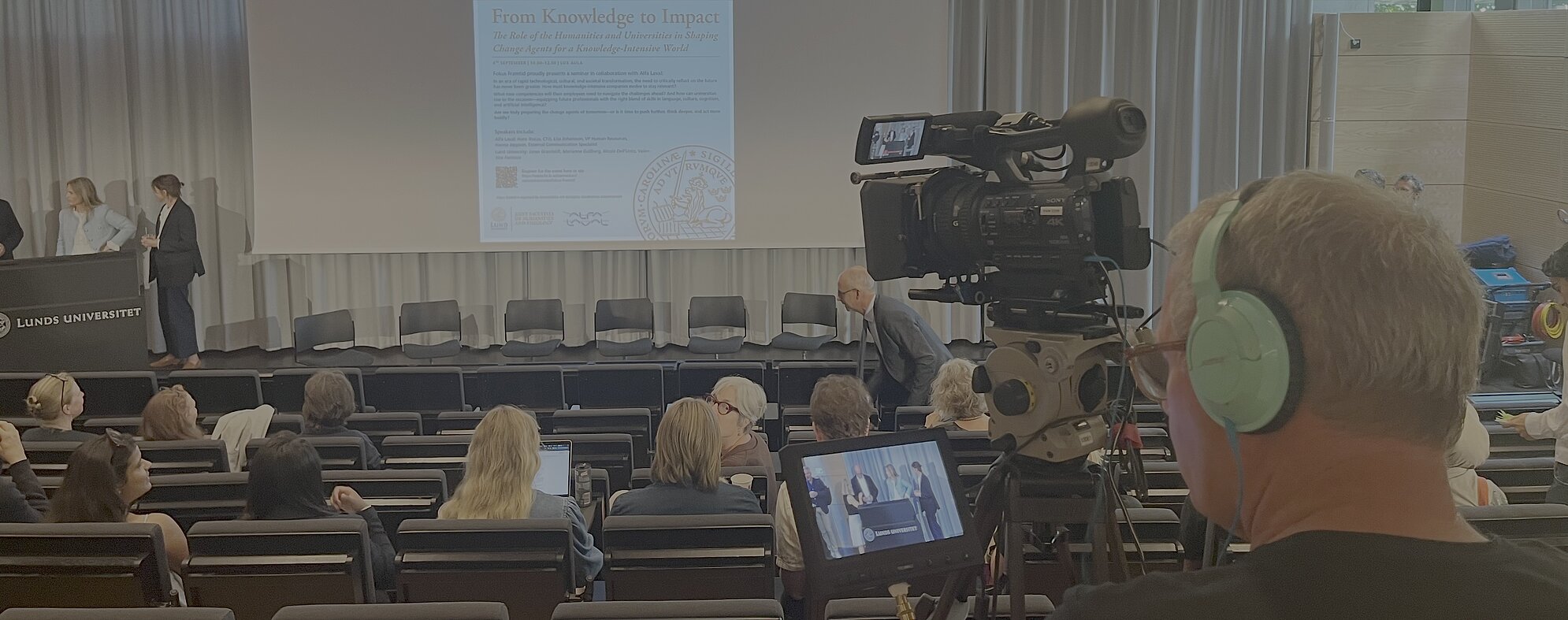 Four people talking seen through a video camera.